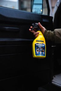 A person showing Rain-X Plastic restorer